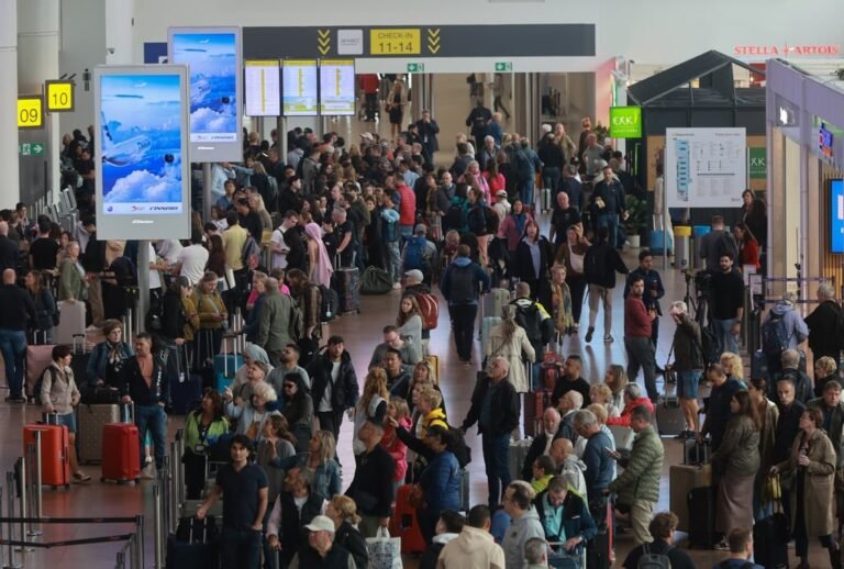 Passengers queue in line at Brussels Airport where dozens of flights were cancelled on Sunday. Photo: EPA