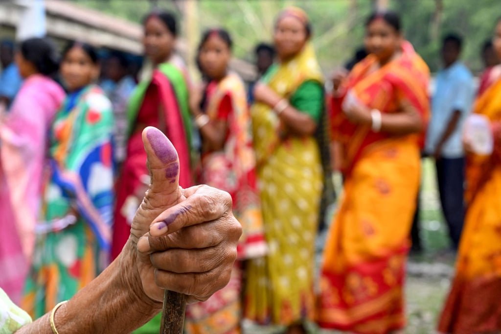 A woman shows her inked finger after voting in West Bengal’s elections in 2024. On Thursday, India started a three-month voter registration overhaul. Photo: AFP