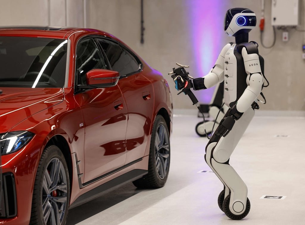 BMW to trial humanoid robots at German factory, as China competition heats up 3 Aeon, a humanoid robotic created by the company Hexagon, works on a car with a laser scanner in Munich, Germany, on Friday. Photo: AFP