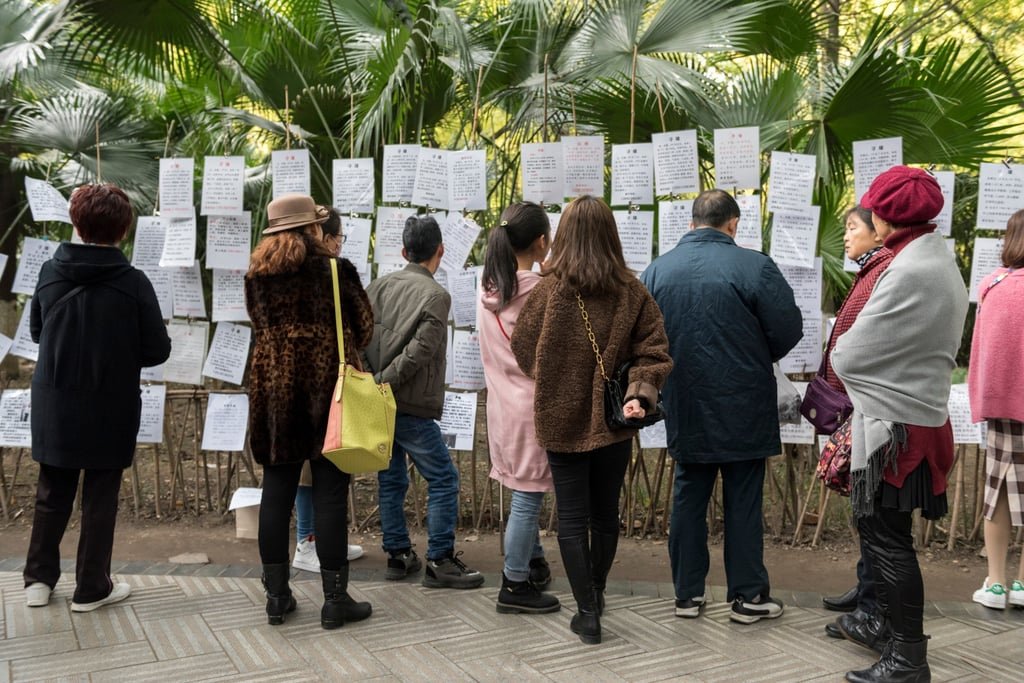 China parents use partner-finding apps for adult kids, turn love transactional 24 People read résumés at a traditional matchmaking corner in China. Photo: Shutterstock