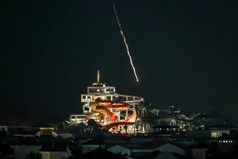 Iran betting Gulf pain will force Trump to seek a deal 26 an entertainment building can be seen as a missile falls from the night sky, leaving a trail